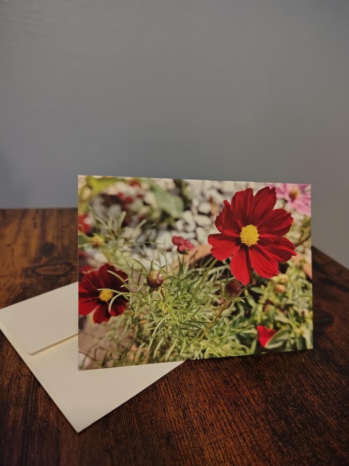 A folded card standing on its white envelope.